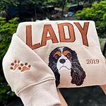 Beige personalized dog portrait sweatshirt embroidered with Lady name, 2019 date, and paw print sleeve