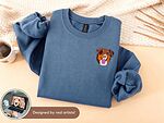 Blue sweatshirt with a custom embroidered brown dog portrait on the left chest