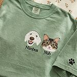 Custom dog and cat portrait embroidered T-shirt in green with pet names and a paw print sleeve detail