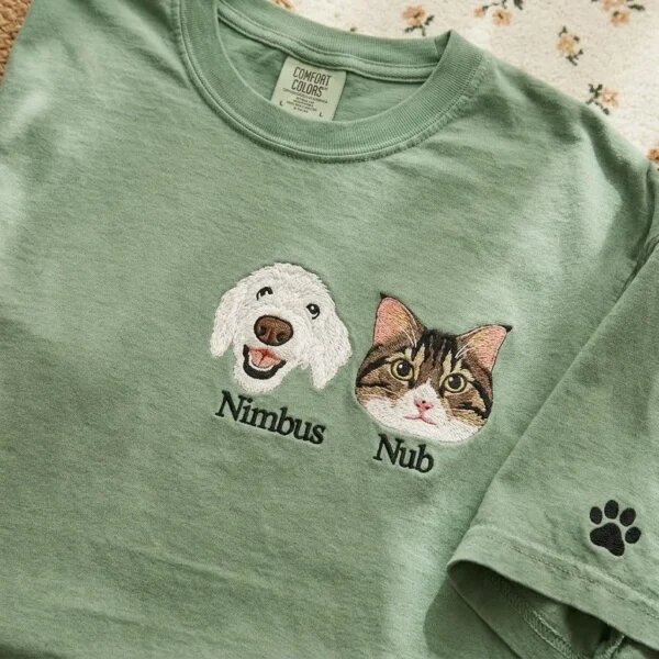 Custom dog and cat portrait embroidered T-shirt in green with pet names and a paw print sleeve detail