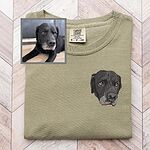 Custom embroidered black dog portrait on a green T-shirt beside the original pet photo