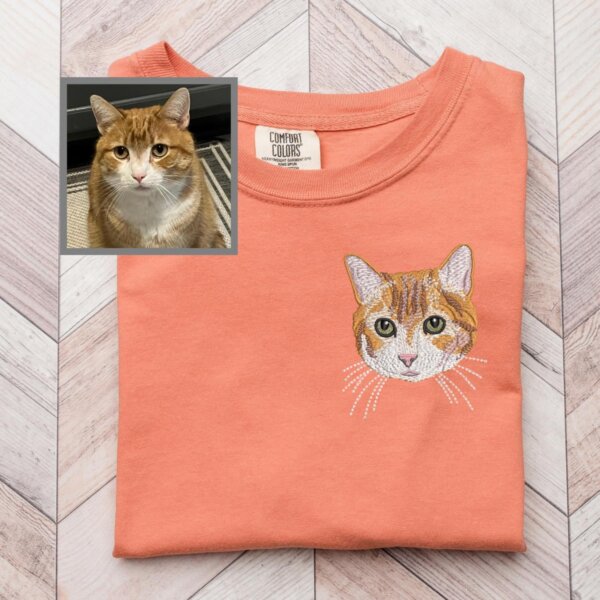 Custom embroidered orange and white cat portrait on a coral T-shirt beside the original pet photo