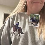 Woman wearing sport grey crewneck sweatshirt with custom embroidered equestrian rider and horse portrait on right chest with photo comparison