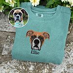 Custom embroidered dog face portrait on sage green sweatshirt with original pet photo inset comparison and embroidered pet name Ellie