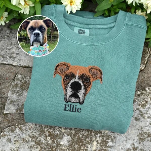 Custom embroidered dog face portrait on sage green sweatshirt with original pet photo inset comparison and embroidered pet name Ellie