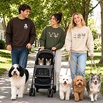 Three people walking dogs while wearing custom pet portrait embroidered sweatshirts