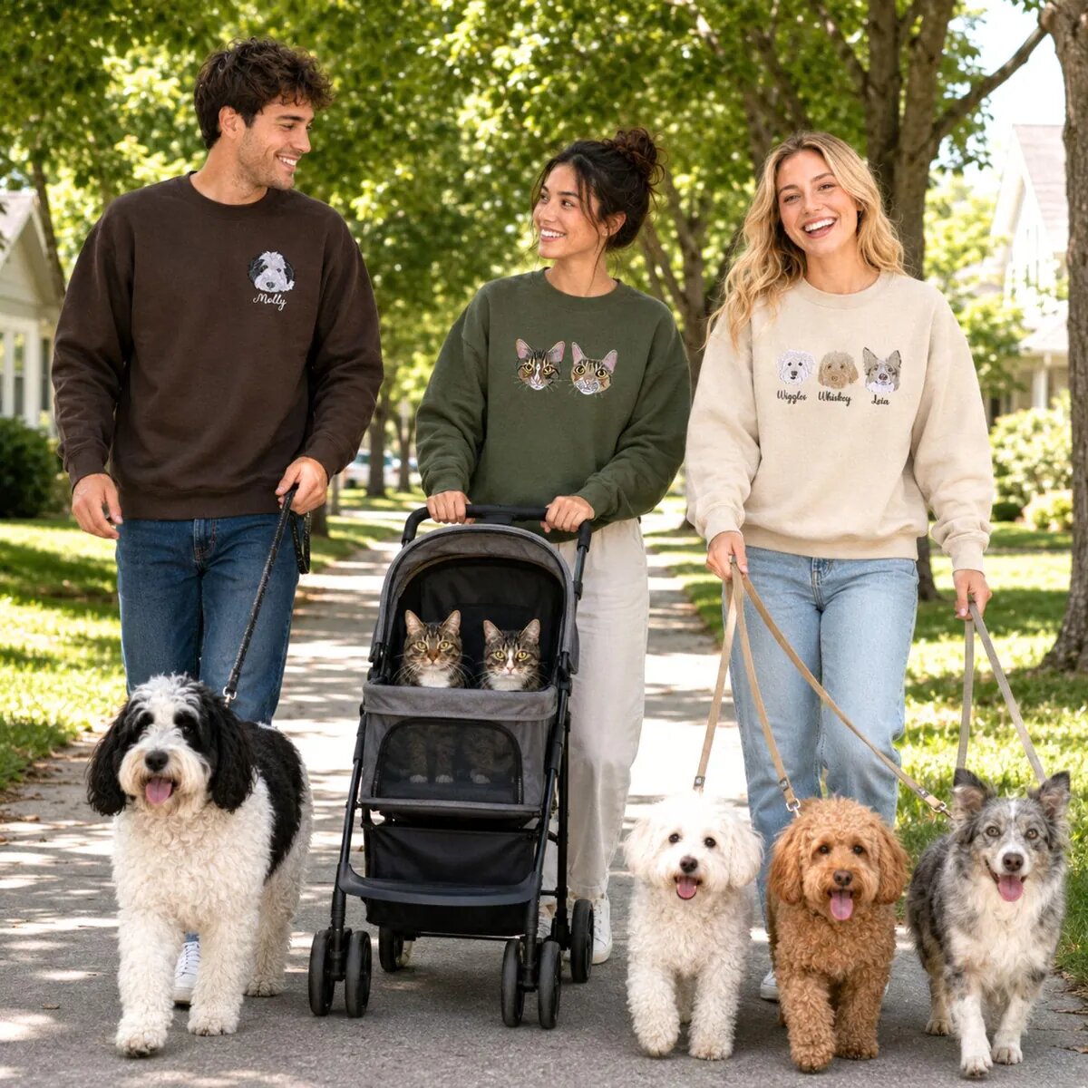Custom Pet Portrait Embroidered Sweatshirts on a Dog Walk Three people walking dogs while wearing custom pet portrait embroidered sweatshirts