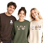Three models wearing custom dog and cat face embroidered sweatshirts on a white background
