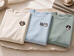Cream, light blue, and sage custom pet portrait sweatshirts with one or two embroidered pets