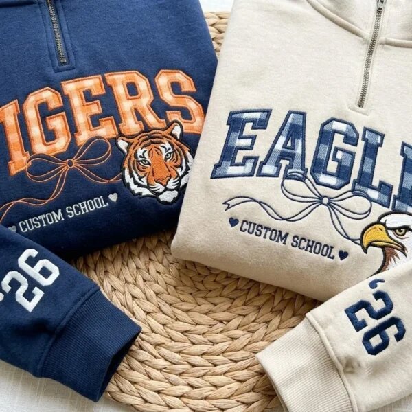 Tigers and Eagles school mascot quarter-zip pullovers with gingham lettering, mascot logos and sleeve year
