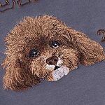 Close-up of brown dog portrait embroidery on a sweatshirt