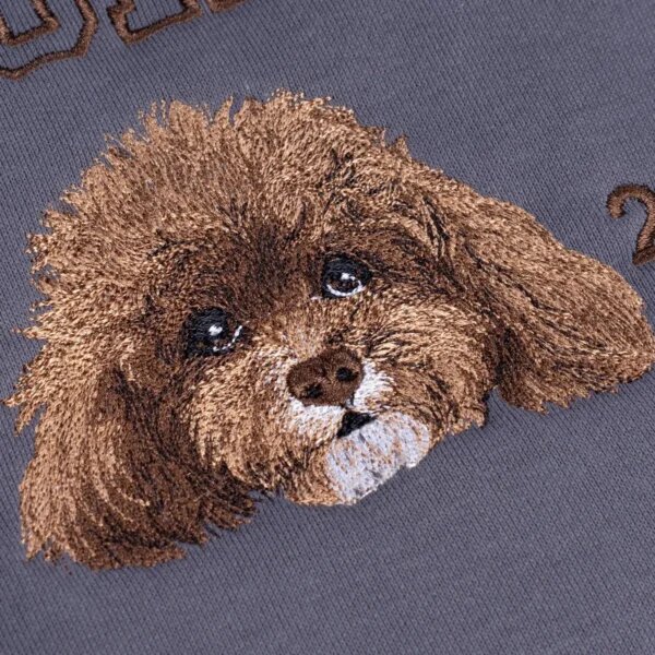 Close-up of brown dog portrait embroidery on a sweatshirt