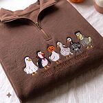 Rich chocolate brown quarter zip fleece sweater with six embroidered geese in Halloween costumes