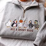 Sport grey quarter zip pullover sweater with colorful embroidered Halloween costume geese on linen background