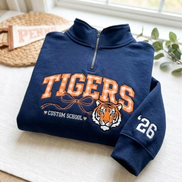 Navy quarter-zip pullover with Tigers gingham lettering, tiger mascot, school text and sleeve year