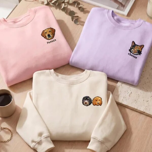 Pink, lavender, and cream personalized pet portrait sweatshirts showing one dog, one cat, and two dogs