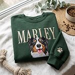Green personalized dog photo embroidery sweatshirt with Marley name and paw print sleeve in a flat lay