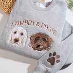 Angled view of sport grey personalized crewneck sweatshirt with two embroidered dog portraits and arched names Cowboy & Posie