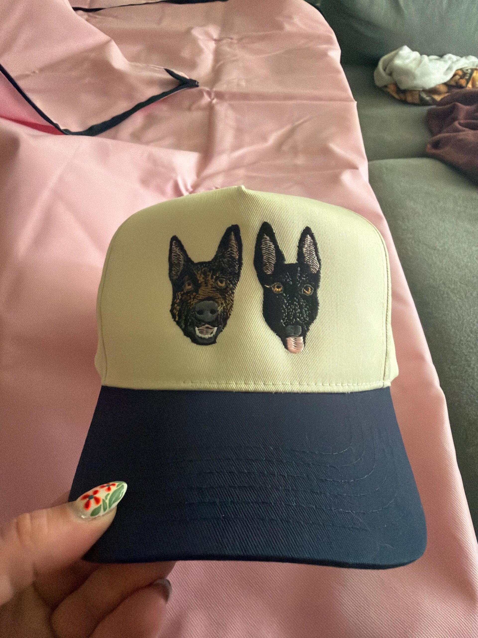 Customer photo of a cream and navy cap with two embroidered dog portraits