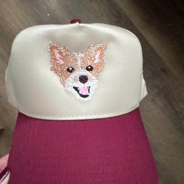 Customer photo of a cream and burgundy cap with a tan-and-white embroidered dog portrait