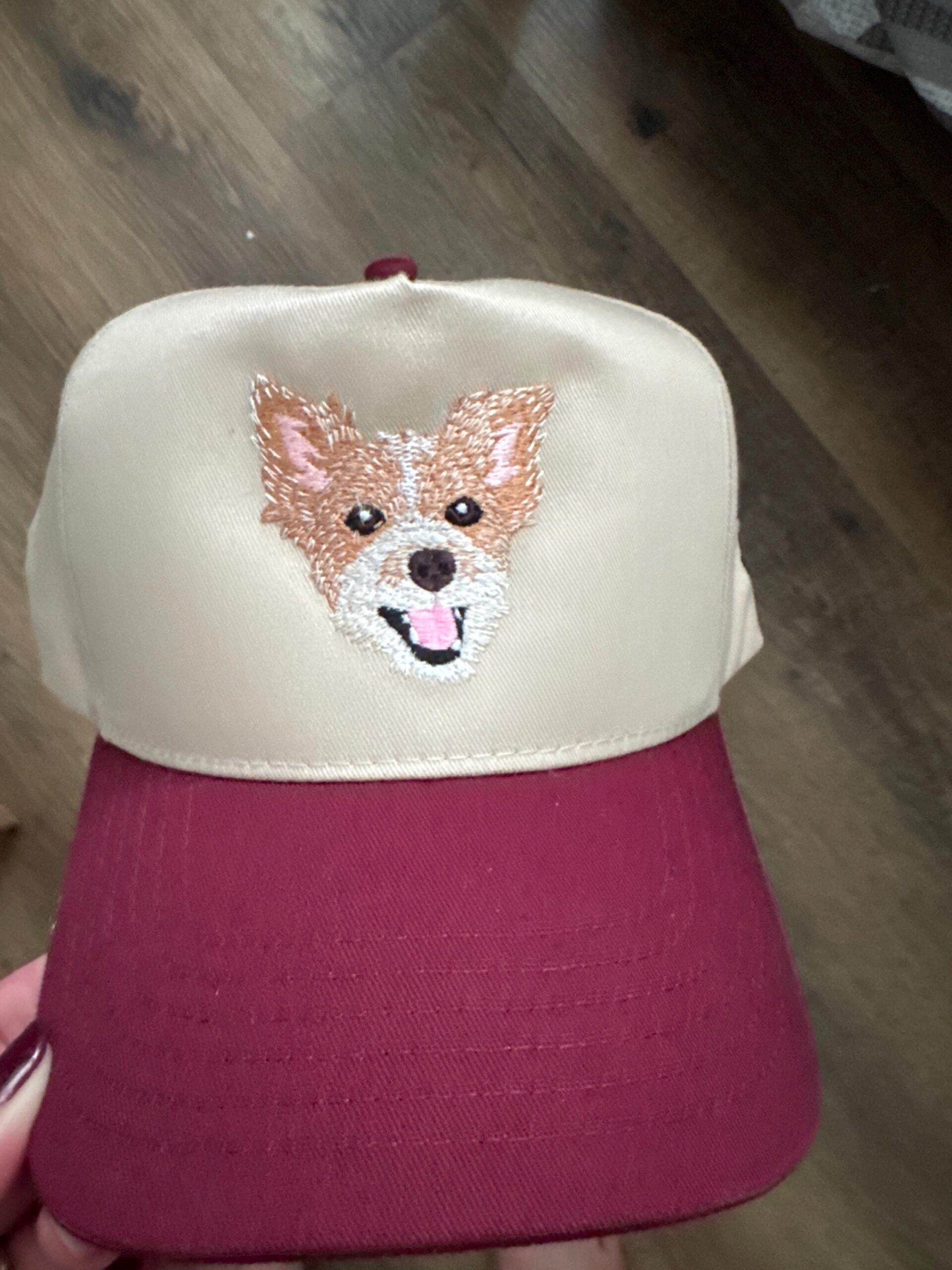 Customer photo of a cream and burgundy cap with a tan-and-white embroidered dog portrait