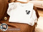 White sweatshirt with a small custom black-and-white dog portrait and artist design preview