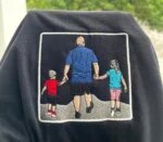 Black embroidered t-shirt with custom family photo embroidery showing a father holding hands with his son and daughter
