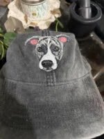 Charcoal grey vintage washed baseball cap showcasing custom embroidered brindle pitbull terrier dog face with white blaze and pink inner ears