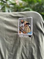 Custom embroidered photo t-shirt featuring an embroidered polaroid portrait of a couple and their dog with custom text with you on olive green fabric