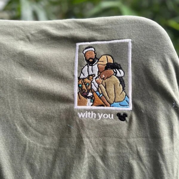 Custom embroidered photo t-shirt featuring an embroidered polaroid portrait of a couple and their dog with custom text with you on olive green fabric