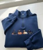 Dark navy quarter zip pullover with vibrant embroidery of costumed Halloween dachshunds carrying smiling jack-o-lantern treat baskets