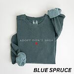 Blue Spruce crewneck sweatshirt laid flat on white, embroidered with ADOPT DON'T SHOP in light spaced capitals and a red heart