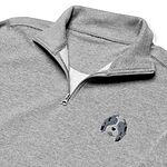 Close-up of a heather grey quarter zip collar and chest, embroidered with a blue merle aussiedoodle face with a white blaze and blue eyes on the left chest