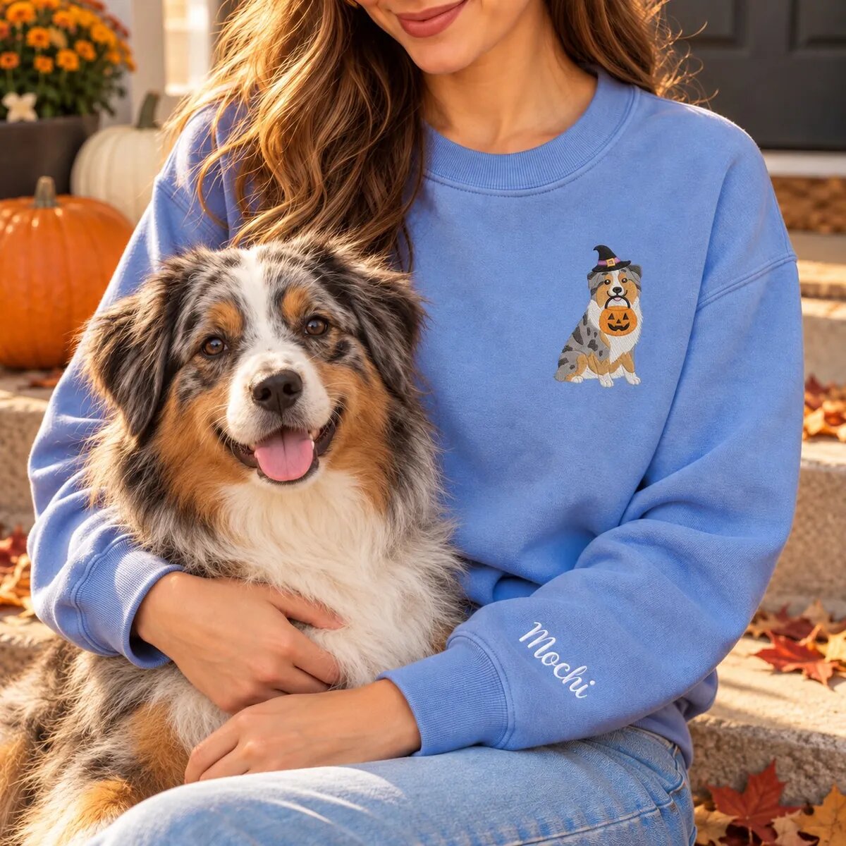 Australian Shepherd Mom Halloween Sweatshirt Worn Australian Shepherd mom wearing the Heather Deep Royal Halloween sweatshirt with her Australian Shepherd on a fall porch