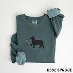 Blue Spruce crewneck sweatshirt laid flat with rolled cuffs, embroidered with a black Australian shepherd silhouette carrying a string of Christmas lights
