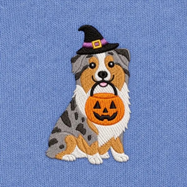 Close-up of the embroidered Australian Shepherd in a witch hat with a jack-o'-lantern candy bucket