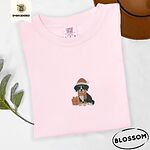 Blossom Comfort Colors T-shirt embroidered with a tricolor Bernese mountain dog puppy in a Santa hat and knit scarf sitting beside a wrapped gift