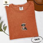 Yam Comfort Colors T-shirt embroidered with a tricolor Bernese mountain dog puppy in a Santa hat and knit scarf sitting beside a wrapped gift