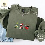 Military Green crewneck sweatshirt folded with light jeans and a silver chain necklace, embroidered with three Bernese mountain dog puppies in a Christmas tree costume, a Santa hat with a red scarf and reindeer antlers with a red sweater