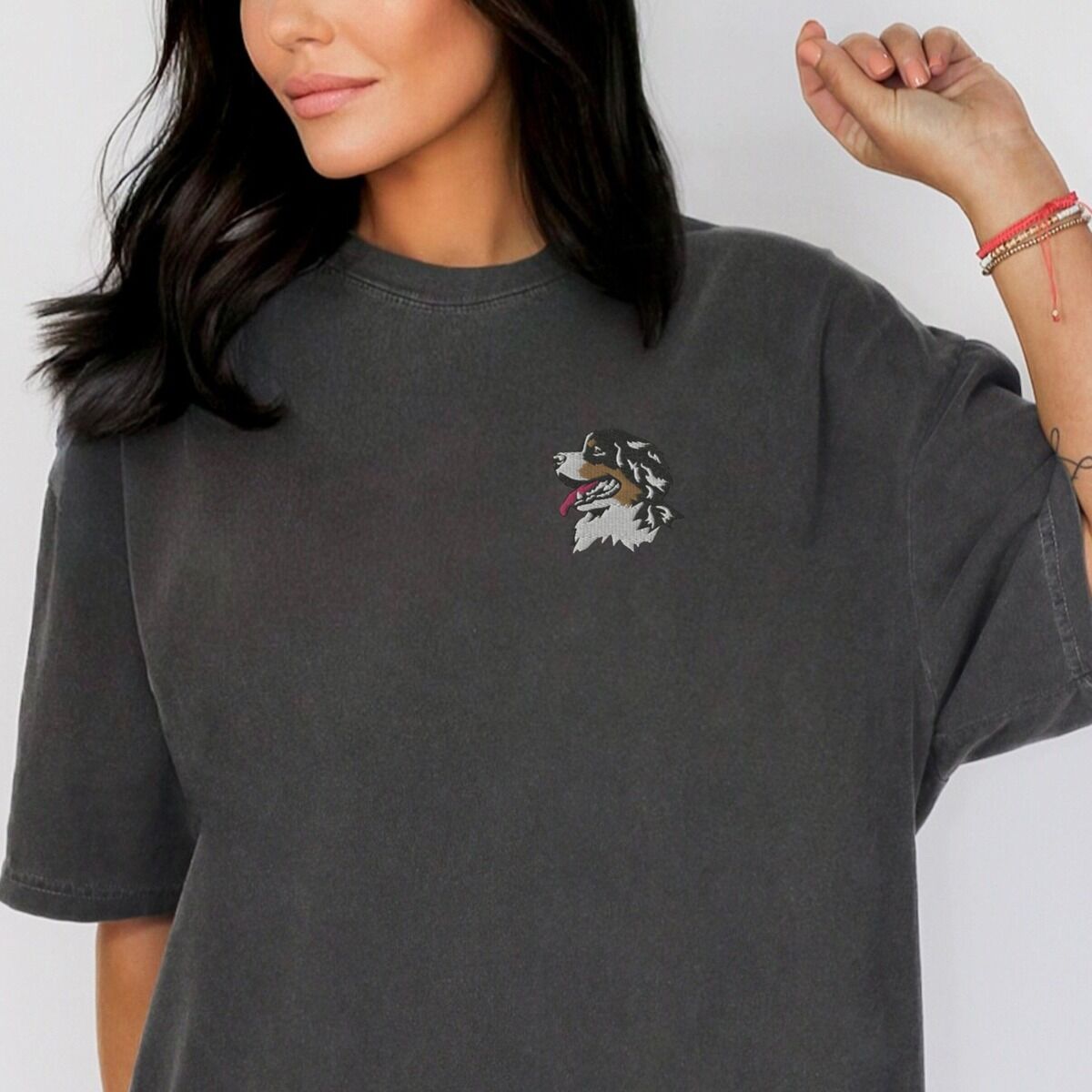 Bernese Mountain Dog Head Shirt – Pepper Woman in a Pepper T-shirt embroidered with a small tricolor Berner head on the left chest