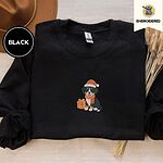 Black crewneck sweatshirt with a brown felt hat and dried bunny tail grass, embroidered with a tricolor Bernese mountain dog puppy in a Santa hat and knit scarf sitting beside a wrapped gift