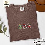 Espresso Comfort Colors T-shirt embroidered with three tricolor Bernese mountain dog puppies in a Christmas tree costume, a Santa hat with a red scarf and reindeer antlers with a red sweater