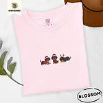 Blossom Comfort Colors T-shirt embroidered with three black and tan dachshunds in Santa hats, a red sweater, a red scarf and reindeer antlers