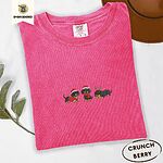 Crunchberry Comfort Colors T-shirt embroidered with three black and tan dachshunds in Santa hats, a red sweater, a red scarf and reindeer antlers