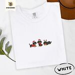 White Comfort Colors T-shirt embroidered with three black and tan dachshunds in Santa hats, a red sweater, a red scarf and reindeer antlers