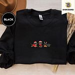 Black crewneck sweatshirt with a brown felt hat and dried bunny tail grass, embroidered with three black and tan dachshunds in Santa hats, a red scarf and reindeer antlers across the chest