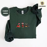 Forest Green crewneck sweatshirt folded on a white background, embroidered with three black and tan dachshunds in Santa hats, a red scarf and reindeer antlers across the chest