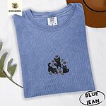 Blue Jean Comfort Colors T-shirt embroidered with three black cats pouncing, leaping and sitting among falling red, orange and yellow autumn leaves