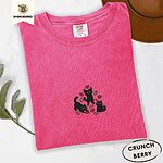 Crunchberry Comfort Colors T-shirt embroidered with three black cats pouncing, leaping and sitting among falling red, orange and yellow autumn leaves