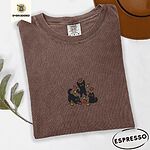 Espresso Comfort Colors T-shirt embroidered with three black cats pouncing, leaping and sitting among falling red, orange and yellow autumn leaves